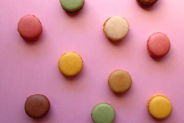 Obraz na płótnie Canvas Colorful macarons on pink background. Top view.
