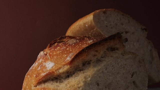 fresh bread with a crispy crust, rotation in circle. sourdough bread, Turning. selective focus. fresh pastries on a brown background