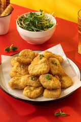 Fast food chicken nuggets paired with a glass of apple juice