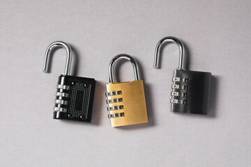 Steel combination padlocks on grey background, top view © New Africa