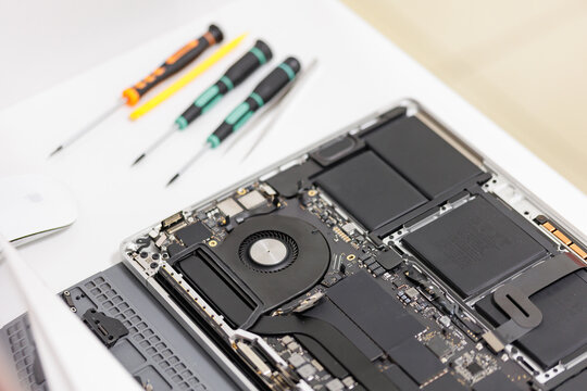RUSSIA - March 23, 2024: Repair Macbook pro Apple, maintenance and replacement of thermal paste, broken screen and replace used rechargeable batteries for recycling