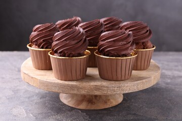 Delicious chocolate cupcakes on grey textured table