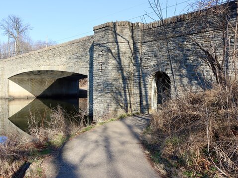 The old stone bridge at the park on a sunny day.