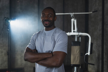 Fitness workout in gym. Portrait of African American man standing in gym with motivation health energy ready for training. Athletic coach personal trainer fitness club owner. Healthy lifestyle
