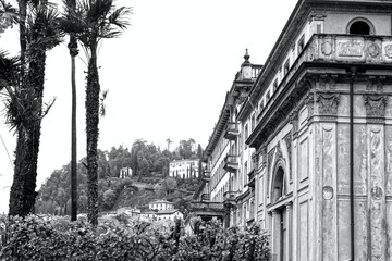 Old building and palm trees in Bellagio on Lake Como in northern Italy in Europe in black and white
