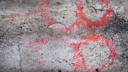 Concrete wall with pink paint marks