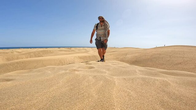 Portrait of male tourist in summer in the dunes of Maspalomas, Gran Canaria, Canary Islands
