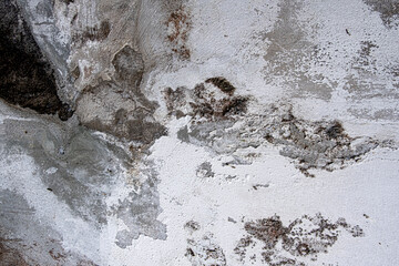 Grey concrete wall with white cement