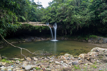 Waterfall surrounded by green vegetation