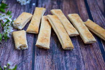 Sfogliatine, an Italian puff pastry with glaze on a plate on  wooden background