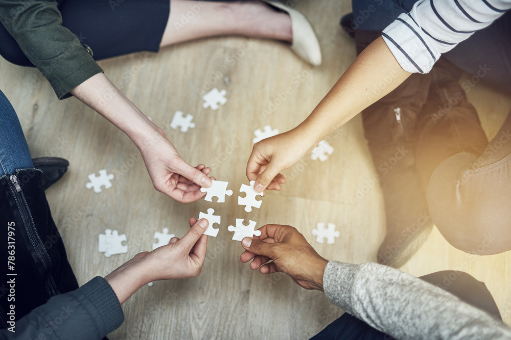 Poster people, support and hands with puzzle on floor for problem solving, strategy and synergy in training
