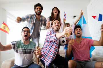 Diverse friends sports fans watching football match on TV at home. Celebrating shouting excited - 786318918