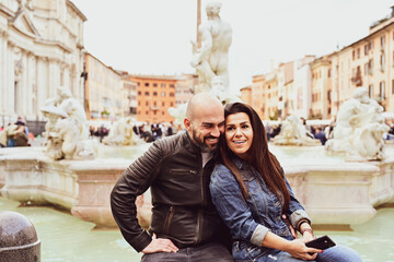 Happy  Beautiful Tourists  couple traveling at Rome, Italy, taking a selfie portrait аt Piazza Navova.Visiting Italy - man and woman enjoying weekend vacation - Happy lifestyle concept 