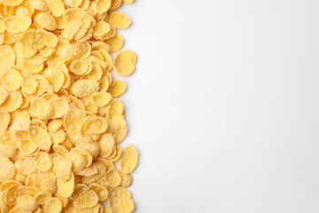 Breakfast cereal. Tasty corn flakes on white background, flat lay. Space for text