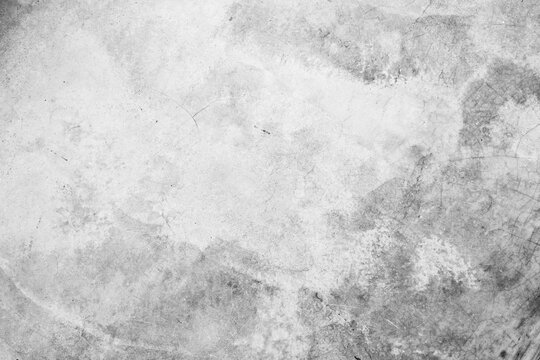 White concrete wall with cracks and scratches, background texture