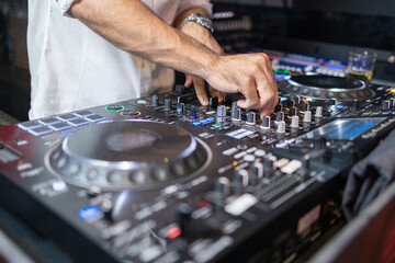 DJ's Hands Adjusting Music Mixer at Event