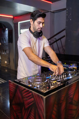 Smiling DJ Mixing Beats at Club Party