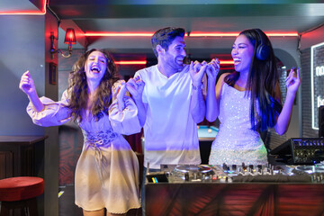 Joyful Friends Dancing at a Club with DJ