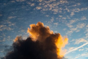 Beautiful yellow clouds in the late afternoon against a cloudy blue sky.