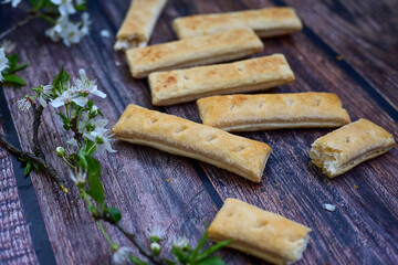 Sfogliatine, an Italian puff pastry with glaze on a plate on  wooden background