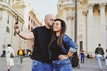 Happy  Beautiful Tourists  couple traveling at Rome, Italy, taking a selfie portrait Visiting Italy - man and woman enjoying weekend vacation - Happy lifestyle concept 