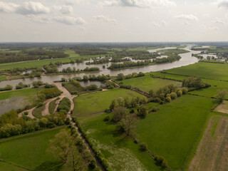 Fototapeta na wymiar Aerial View: Countryside Road along the IJssel River Dike in Netherlands