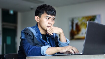 Serious young adult business executive, brainstorming at work. Serious business man working at home having problem with job thinking to solve problem.