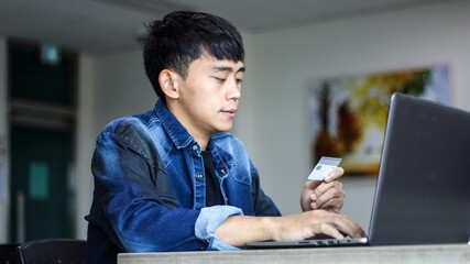 close up of man with laptop computer and credit card at home. technology, shopping, banking, home...