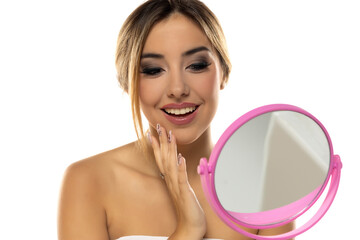 Woman Beauty Face Care. Portrait Of Beautiful Happy Young Female With Fresh Healthy Skin Looking In Mirror. Closeup Of Attractive Healthy Smiling Girl With Fresh Natural Face Makeup. White Background