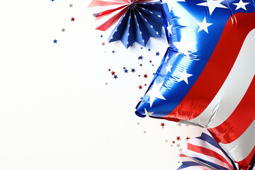 Flat lay American balloon, paper fans, confetti on white background. 4th of July Independence Day...