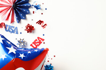 Flat lay American balloon, signs USA, paper fans on white background. 4th of July Independence Day...