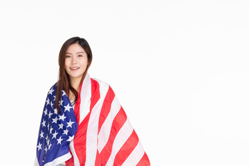 Young woman smiling standing on street holding confident holding united states flag over isolated...