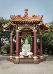 White Jade Gautama Buddha Statue Sitting on Lotus in pavilion. The Shakyamuni Meditating Buddha at Fo Guang Shan Thaihua Temple, Space for text, Selective focus.