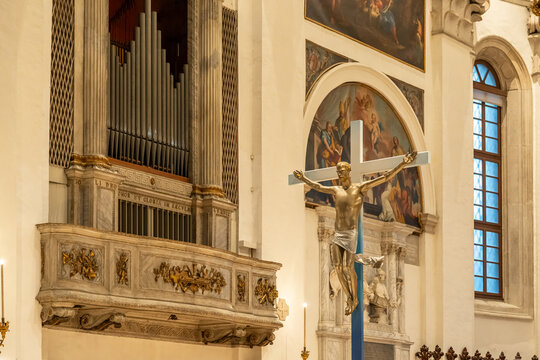 View of organ and big crucifix inside catholic church in Italy