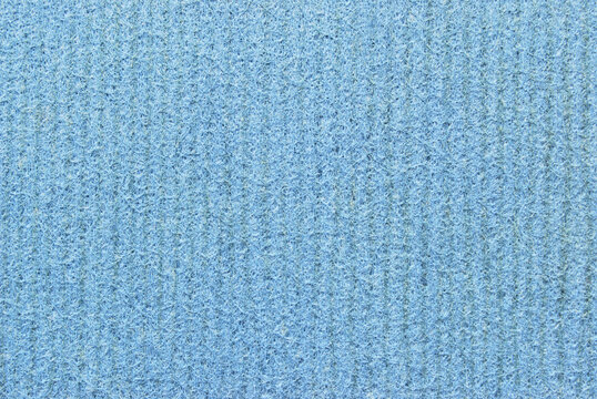 A sheet of porous, fibrous, and ribbed texture as background
