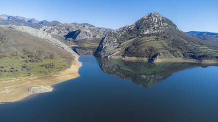 aerial view of the Porma reservoir in the province of León, Spain. With reflections of mountains in the water