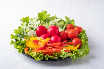 Raw fresh vegetables on a plate. Diet food concept. White background