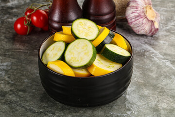 Sliced raw young green and yellow zucchini