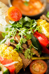 Dutch skewers with corn and cow steak, vegetables and sauce