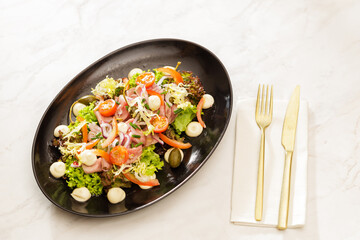Fresh Vegetable Salad on black plate
