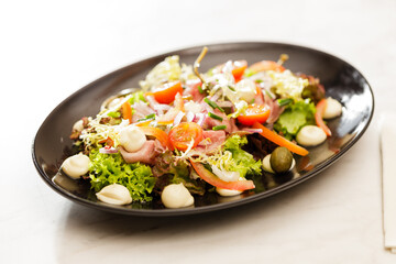 Fresh Vegetable Salad on black plate