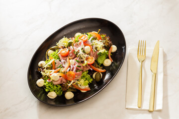 Fresh Vegetable Salad on black plate