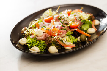 Fresh Vegetable Salad on black plate