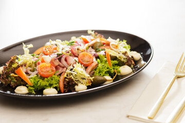Fresh Vegetable Salad on black plate