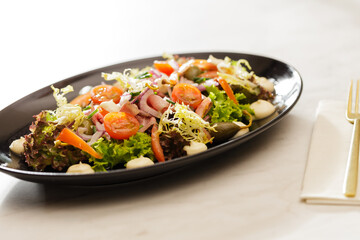 Fresh Vegetable Salad on black plate