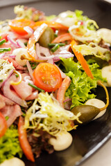 Fresh Vegetable Salad on black plate