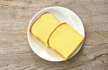 butter vanilla cheesecake cutting in square shape on plate