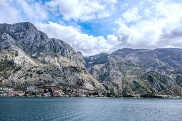 Panoramic landscape with old church in Kotor, Montenegro.Harbor and boats on a sunny day in Boka Kotorska bay, Montenegro, Europe.