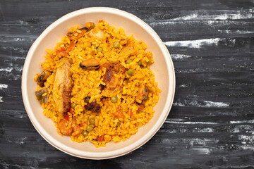 typicla spanish dish paella in plastic plate
