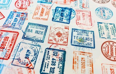 A white page features various passport stamps from different countries, creating an international vibe with colors including red and blue.